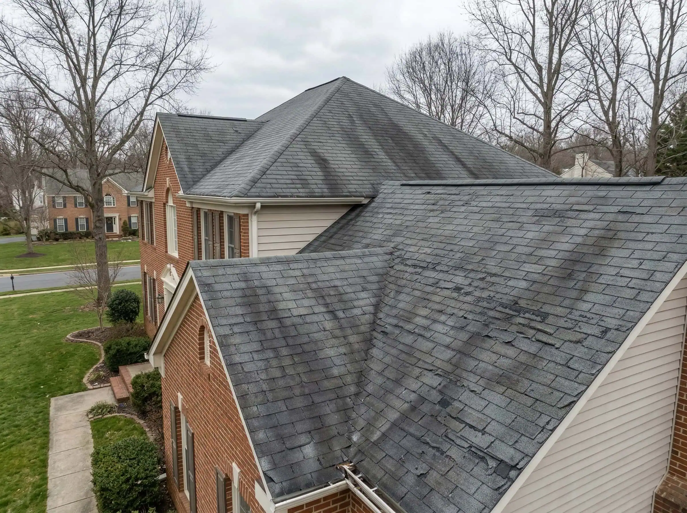 Aging asphalt roof before DreamHome replacement — Fairfax County Virginia — granule loss and algae streaking visible